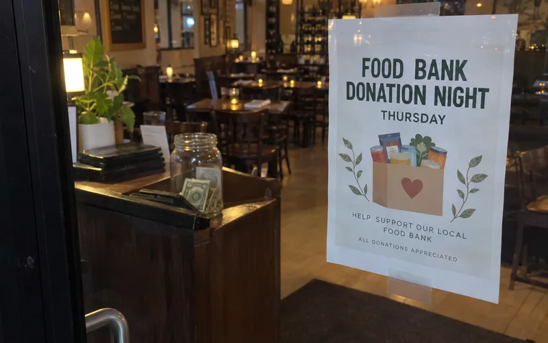 Flyer for a food bank donation night on a restaurant door