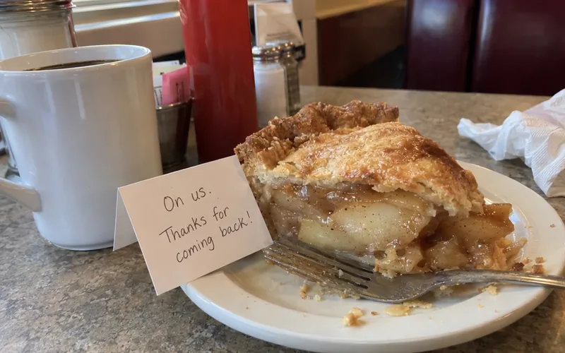 Slice of pie on the house with a handwritten thank-you note