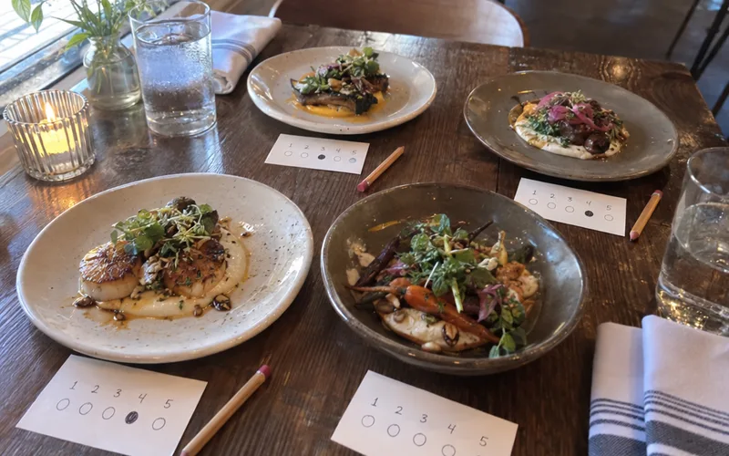 Tasting plates of new dishes with rating cards for regulars